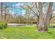 Scenic backyard with mature trees and access to a tranquil pond, adding natural beauty to the property at 5734 Hillside Ave, Indianapolis, IN 46220