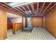 Spacious basement with retro flooring and exposed ceiling, offering potential for customization at 5734 Hillside Ave, Indianapolis, IN 46220