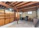Unfinished basement space featuring exposed beams, small windows, and potential for storage or workshop at 5734 Hillside Ave, Indianapolis, IN 46220