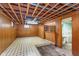 Unfinished basement space with wood paneling and exposed ceiling, ready for renovation at 5734 Hillside Ave, Indianapolis, IN 46220