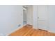 Bedroom features hardwood floors, neutral walls, and convenient closet access for storage at 5734 Hillside Ave, Indianapolis, IN 46220