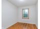 Simple bedroom with hardwood floors, white walls, and a window providing natural light and ventilation at 5734 Hillside Ave, Indianapolis, IN 46220