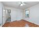 Bedroom with hardwood floors, a ceiling fan, and neutral walls, creating a calm atmosphere at 5734 Hillside Ave, Indianapolis, IN 46220