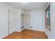 Bedroom featuring hardwood floors, two closets, natural light, and neutral decor at 5734 Hillside Ave, Indianapolis, IN 46220