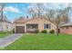 Charming single-story home featuring a well-maintained lawn and attached garage at 5734 Hillside Ave, Indianapolis, IN 46220