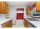 Kitchen featuring wood cabinets, white countertops, and a stainless steel sink at 5734 Hillside Ave, Indianapolis, IN 46220