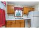 Kitchen with wood cabinets, white countertops, and stainless steel appliances at 5734 Hillside Ave, Indianapolis, IN 46220