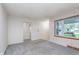 Bright and airy living room featuring neutral paint, large windows, and carpeting at 5734 Hillside Ave, Indianapolis, IN 46220