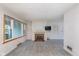 Spacious living room featuring a brick fireplace, large windows, and carpet flooring at 5734 Hillside Ave, Indianapolis, IN 46220