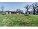 Expansive backyard showcasing the home's exterior, a storage shed, and ample green space, perfect for outdoor enjoyment at 6047 W 56Th St, Indianapolis, IN 46254