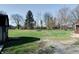 Expansive backyard with mature trees, large grassy area, and a shed on the side of the yard at 6047 W 56Th St, Indianapolis, IN 46254