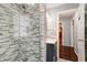 A stylish bathroom with a tiled shower, vanity with storage, and bright lighting at 6047 W 56Th St, Indianapolis, IN 46254