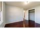 A bedroom with hardwood flooring, painted walls, and a walk-in closet at 6047 W 56Th St, Indianapolis, IN 46254