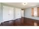 A bedroom with hardwood flooring, painted walls, and a double door closet at 6047 W 56Th St, Indianapolis, IN 46254