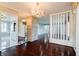 Dining room featuring mirrored walls, hardwood flooring and a decorative chandelier at 6047 W 56Th St, Indianapolis, IN 46254