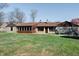 Exterior view of the house with a backyard and sunroom providing natural light and a blend of indoor-outdoor living at 6047 W 56Th St, Indianapolis, IN 46254