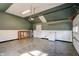 Well-lit garage featuring painted walls, wainscotting, tiled floor, utility sink, and garage door at 6047 W 56Th St, Indianapolis, IN 46254