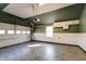 View of a clean, organized garage space with updated lighting at 6047 W 56Th St, Indianapolis, IN 46254