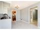 Open kitchen with white marble floors, white cabinets and view of multiple rooms at 6047 W 56Th St, Indianapolis, IN 46254