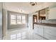 Bright kitchen features white marble floors, white cabinets and view of the front yard at 6047 W 56Th St, Indianapolis, IN 46254