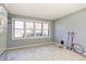 A versatile room with natural light from large windows, neutral walls, and tile flooring at 6047 W 56Th St, Indianapolis, IN 46254