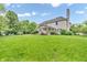 Large backyard with green grass, mature trees, a covered patio, and a basketball hoop at 6071 Sugar Pine Dr, Avon, IN 46123