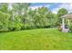 Spacious backyard with lush green lawn, mature trees, and a charming seating area at 6071 Sugar Pine Dr, Avon, IN 46123