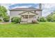 Expansive backyard featuring a covered patio, lush green grass, and mature trees at 6071 Sugar Pine Dr, Avon, IN 46123