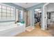 A bathtub and glass-enclosed shower are displayed, with a walk-in closet through the doorway at 6071 Sugar Pine Dr, Avon, IN 46123