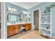 This primary bathroom features double sinks, wood cabinets, and decorative shelving at 6071 Sugar Pine Dr, Avon, IN 46123