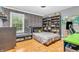 Bedroom with a window seat, brick accent wall, and built-in shelving with decor and books at 6071 Sugar Pine Dr, Avon, IN 46123