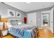 Comfortable bedroom features wood floors, fresh paint, and a cozy bed with a gray throw blanket at 6071 Sugar Pine Dr, Avon, IN 46123