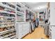 A walk-in closet has custom shelving for shoes and clothes, plus storage at the top at 6071 Sugar Pine Dr, Avon, IN 46123