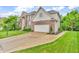 A lovely two-story home featuring brick and vinyl siding, a paved driveway, and an attached two-car garage at 6071 Sugar Pine Dr, Avon, IN 46123