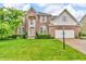 Charming two-story brick home with a well-manicured lawn and arched entryway at 6071 Sugar Pine Dr, Avon, IN 46123