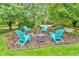Cozy backyard firepit area with Adirondack chairs and a hammock surrounded by lush greenery at 6071 Sugar Pine Dr, Avon, IN 46123