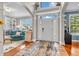 Bright entryway with hardwood flooring, a stylish rug, and views into the home's living spaces at 6071 Sugar Pine Dr, Avon, IN 46123