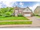 Charming two-story brick home with lush green lawn, landscaping, and a paved driveway at 6071 Sugar Pine Dr, Avon, IN 46123