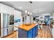 Kitchen showcasing stainless appliances, blue island with wood top, with adjacent living and dining spaces at 6071 Sugar Pine Dr, Avon, IN 46123