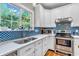 Bright kitchen featuring white cabinets, stainless steel appliances, and a window for natural lighting at 6071 Sugar Pine Dr, Avon, IN 46123