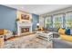 Cozy living room featuring a fireplace, comfortable seating, and large windows at 6071 Sugar Pine Dr, Avon, IN 46123