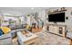 Open-concept living area with hardwood floors and seamless access to the kitchen and staircase at 6071 Sugar Pine Dr, Avon, IN 46123