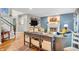 Open layout featuring a living area with a fireplace, a staircase, and a furniture island at 6071 Sugar Pine Dr, Avon, IN 46123