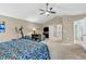 Main bedroom features a ceiling fan, seating area, vaulted ceilings, carpet, and natural light at 6071 Sugar Pine Dr, Avon, IN 46123