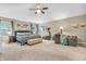 Spacious main bedroom features a seating area, ceiling fan, carpeted floors and ample natural light at 6071 Sugar Pine Dr, Avon, IN 46123