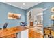Spacious office area with a hardwood desk, arched entrance, and stylish interior design elements at 6071 Sugar Pine Dr, Avon, IN 46123