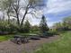 Community park with picnic tables, mature trees and maintained lawns for outdoor enjoyment at 6071 Sugar Pine Dr, Avon, IN 46123
