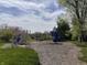 Community playground with blue slides and climbing structures surrounded by mulch at 6071 Sugar Pine Dr, Avon, IN 46123