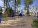 Community playground with blue and white play equipment, swings, and slide on mulch at 6071 Sugar Pine Dr, Avon, IN 46123