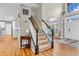 Classic staircase with wood railing and carpeted steps leads to the home's upper level at 6071 Sugar Pine Dr, Avon, IN 46123